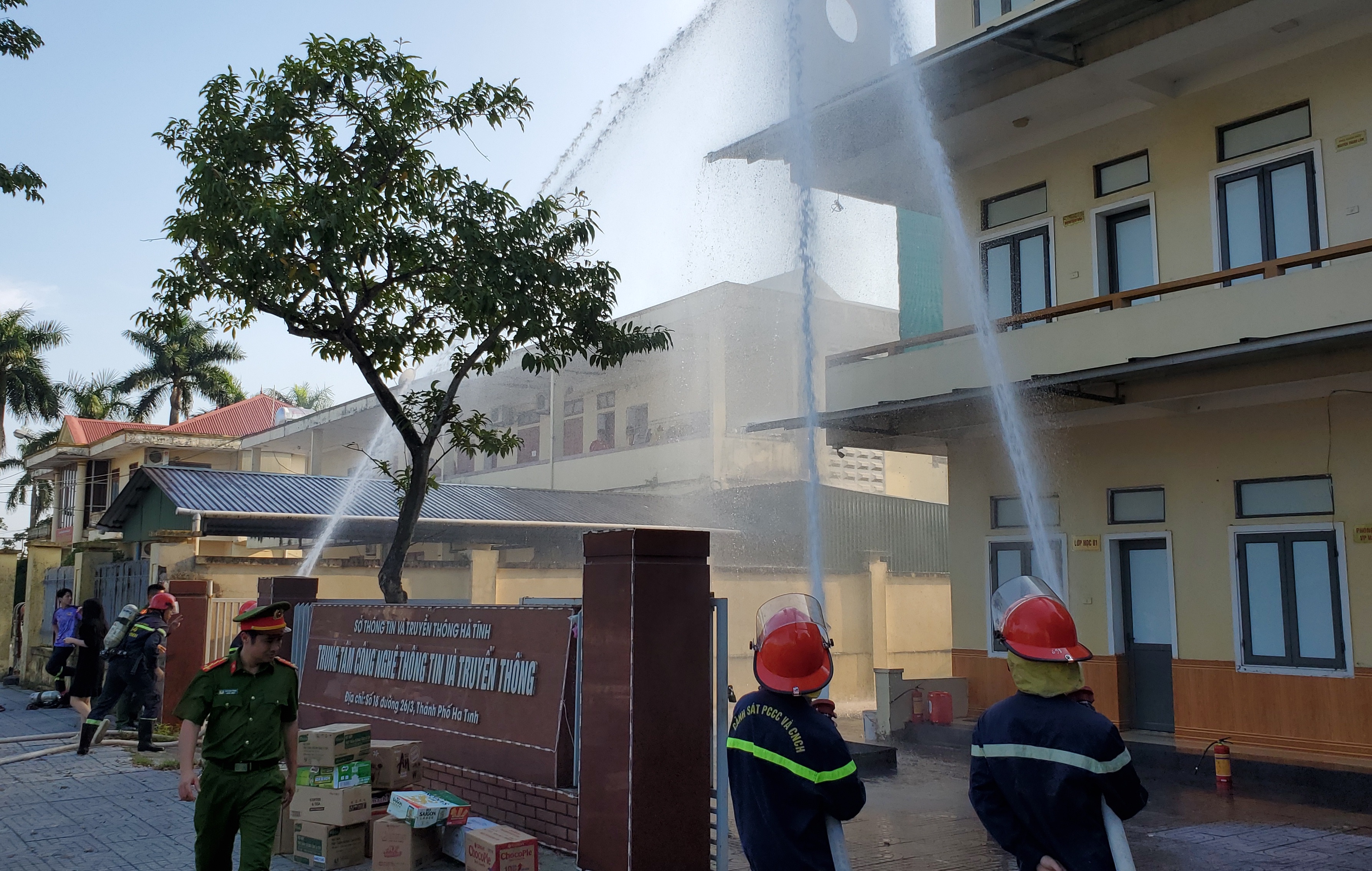 A group of firefighters spraying waterDescription automatically generated